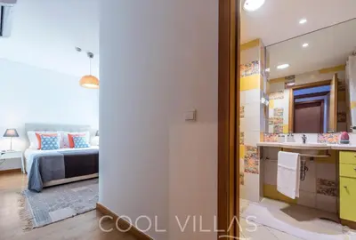 a bedroom with a bed and a bathroom with a mirror at Marina Water View - 6 people, bars & restaurants in Albufeira