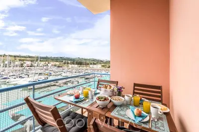 a table with food on a balcony with a view of a marina at Marina Water View - 6 people, bars & restaurants in Albufeira