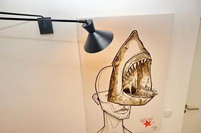 a lamp with a drawing of a screaming mouth at Son of a Beach Hostel in Albufeira
