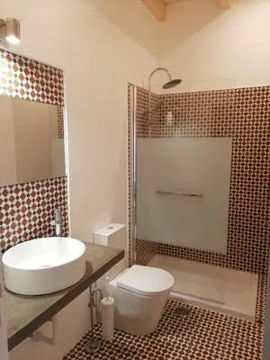 a bathroom with a sink and a toilet and a shower at Son of a Beach Hostel in Albufeira