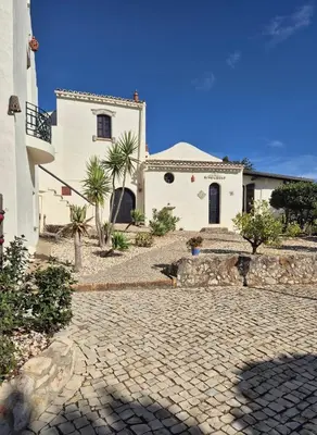 a bathroom with a shower with a stone wall at Monte Borboleta - Villas, Apartments in Faro