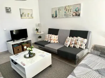 a living room with a couch and a coffee table at Quinta Shiamar in Quarteira