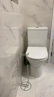 a bathroom with a white toilet in a room at Quinta Shiamar in Quarteira