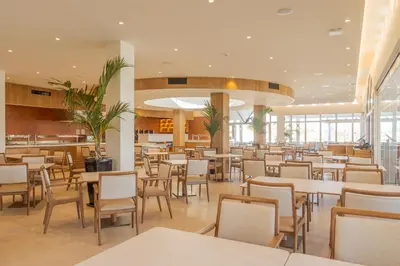 a restaurant with tables and chairs in a cafeteria at Hapimag Resort Albufeira in Albufeira