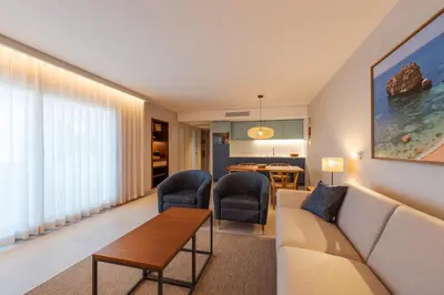 a living room with a couch and chairs and a table at Hapimag Resort Albufeira in Albufeira