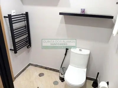 a bathroom with a toilet with a sign on the wall at Moradia Townhouse S Sebastião F in Guia