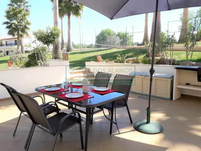 a table with chairs and an umbrella on a patio at Moradia Townhouse S Sebastião F in Guia