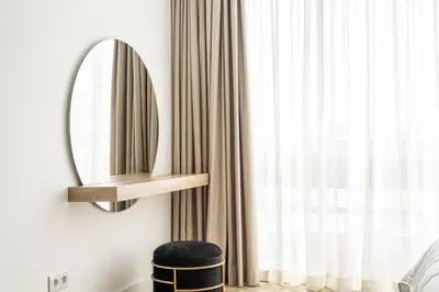 a mirror on a wall next to a window at Estúdios Marina in Vilamoura