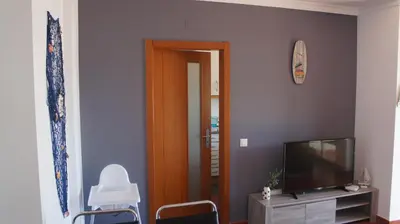a living room with a television and a mirror at Pool & Garden Oura Albufeira Flat in Albufeira