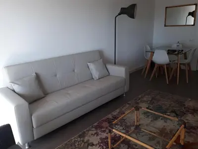 a living room with a white couch and a table at Victory Village Club in Quinta do Lago