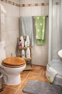 a bathroom with a toilet and a shower and towels at Fisherman´s beach apartment in Albufeira