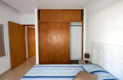 a bedroom with a bed and a wooden door at Old Town Sant'ana T2 in Albufeira