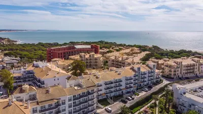 an aerial view of a city and the ocean at Apartamento Praia da Oura in Albufeira