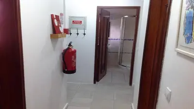 a fire extinguisher is hanging on a wall in a bathroom at Casa Esperança in Albufeira