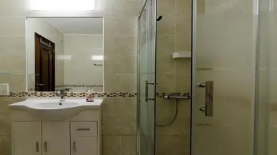 a bathroom with a sink and a shower with a mirror at Casa Esperança in Albufeira