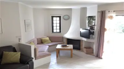 a living room with a couch and a table at Casa Esperança in Albufeira