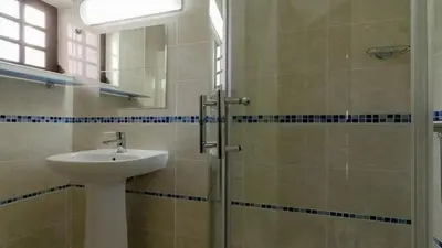 a bathroom with a sink and a shower at Casa Esperança in Albufeira