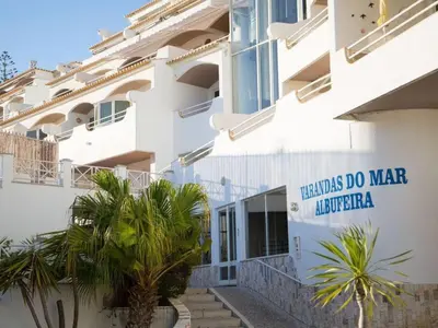 a building with a sign that reads needles do war influenza at RosaMar apartment sea view and pool in Albufeira
