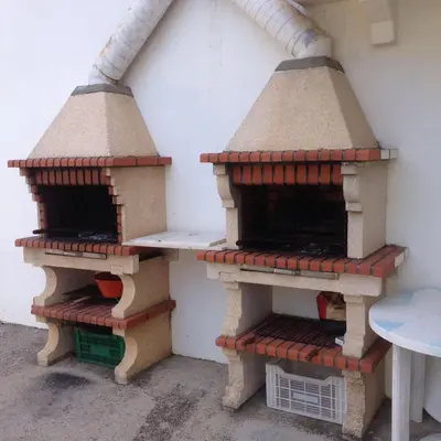 two pizza ovens sitting on the side of a building at Apartamento Lara in Albufeira