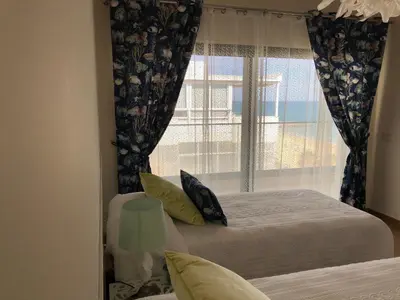 a bedroom with a bed and a window at ocean blue in Quarteira