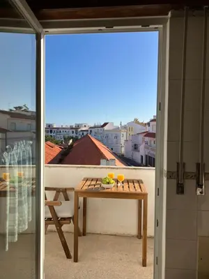 a table on a balcony with a view of a city at KAP Sea View Balcony in Albufeira