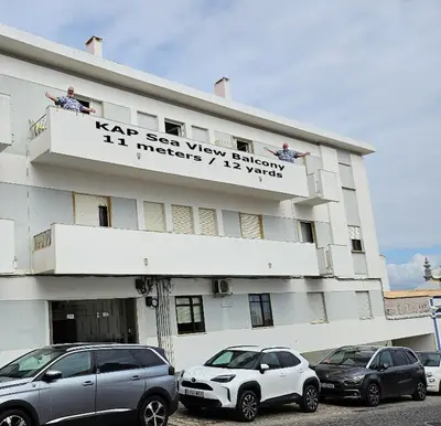 a building with cars parked in front of it at KAP Sea View Balcony in Albufeira