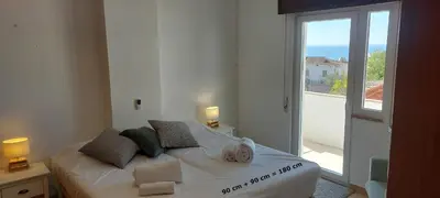 a bedroom with a bed with a view of the ocean at KAP Sea View Balcony in Albufeira