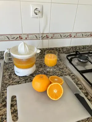 a kitchen counter with oranges on a cutting board at KAP Sea View Balcony in Albufeira