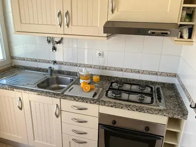 a kitchen with a sink and a stove at KAP Sea View Balcony in Albufeira