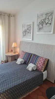 a living room with a bed and a kitchen at Musa Mar studio with balcony panoramic view in the residential area in Quarteira