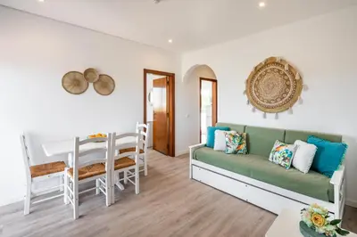 a living room with a couch and a table at Apartamentos Flor da Laranja, Albufeira by AlgarveBlossom in Albufeira