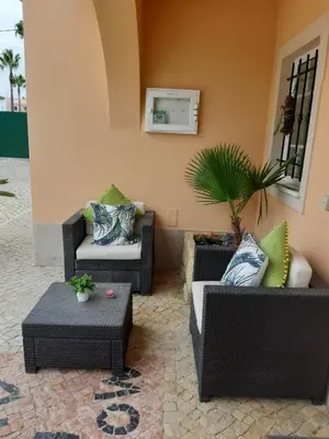 a patio with couches and a table and a plant at Apartamentos Monte dos Avós, Albufeira by AlgarveBlossom in Albufeira