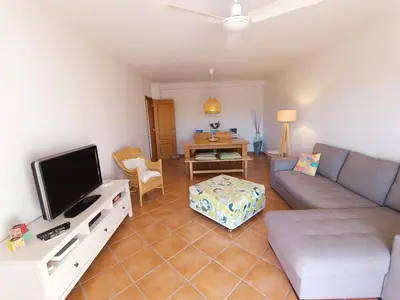 a living room with a couch and a tv at Beauty by the Sea in Albufeira