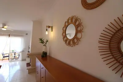 a living room with a mirror on the wall at Beauty by the Sea in Albufeira