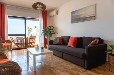 a living room with a couch and a table at Carol & Vany in Quarteira