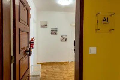 an open door to a hallway with a room with a floor at Carol & Vany in Quarteira