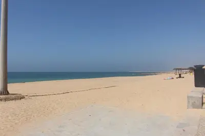 a sandy beach with the ocean in the background at Carol & Vany in Quarteira