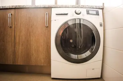 a washing machine sitting next to a wooden cabinet at Apart JCMar - Near to the beach - WIFI - BY BEDZY in Albufeira