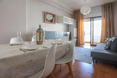 a dining room with a table and chairs and a room at Apart JCMar - Near to the beach - WIFI - BY BEDZY in Albufeira