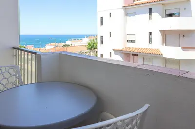 a table on a balcony with a view of the ocean at Apart JCMar - Near to the beach - WIFI - BY BEDZY in Albufeira