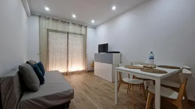 a living room with a table and a couch at Apart JCMar - Near to the beach - WIFI - BY BEDZY in Albufeira