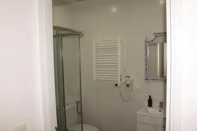 a bathroom with a shower and a toilet and a sink at Casa da avó Bia in Faro