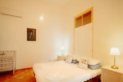 a bedroom with a white bed in a room at Casa da avó Bia in Faro