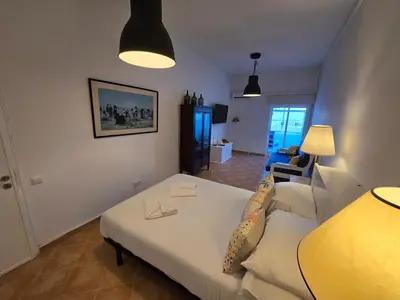a living room with a white couch and a table at Casa da avó Bia in Faro