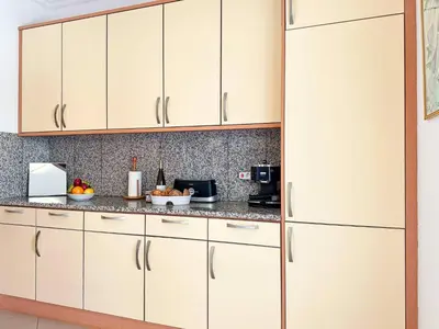 a kitchen with white cabinets and a refrigerator at Modern Ocean, Garden & Pool view Condo by BeCherish in Albufeira