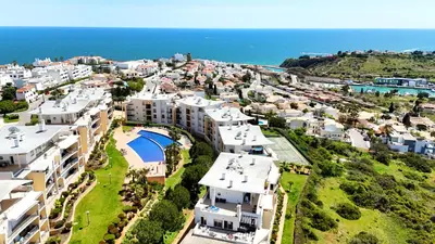 an aerial view of a city with houses and the ocean at Modern Ocean, Garden & Pool view Condo by BeCherish in Albufeira