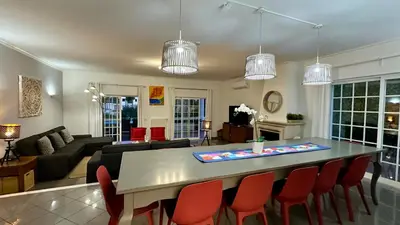 a kitchen and living room with a table and chairs at Fonte Santa by Check-in Portugal in Quarteira