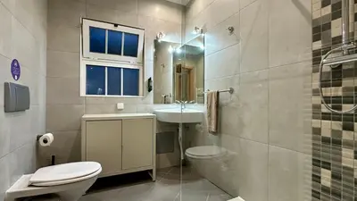 a bathroom with a toilet and a sink and a mirror at Fonte Santa by Check-in Portugal in Quarteira