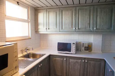 a kitchen with a microwave and a sink at Marina Apartment in Quarteira