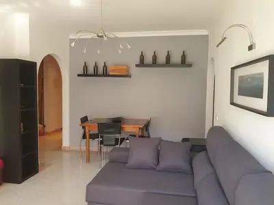 a living room with a couch and a table at Austral Apartment in Quarteira
